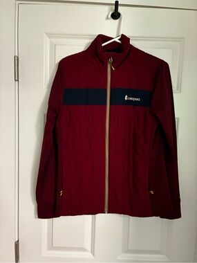 Cotopaxi Maroon Jacket with Navy Chest Stripe and Yellow Zipper